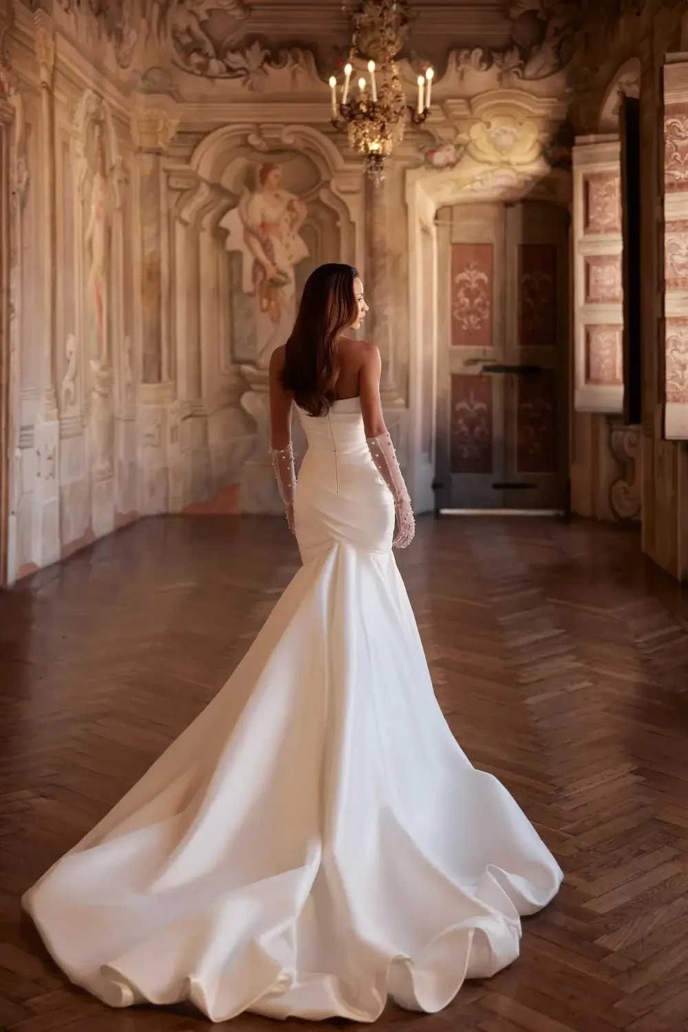 model is wearing a strapless wedding gown