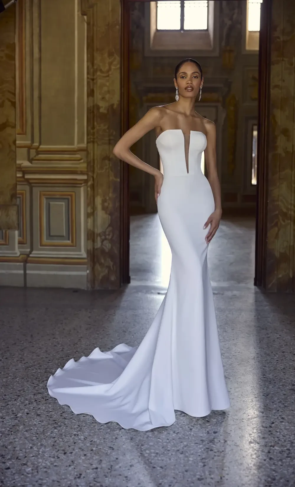 model is wearing a strapless open back bridal gown